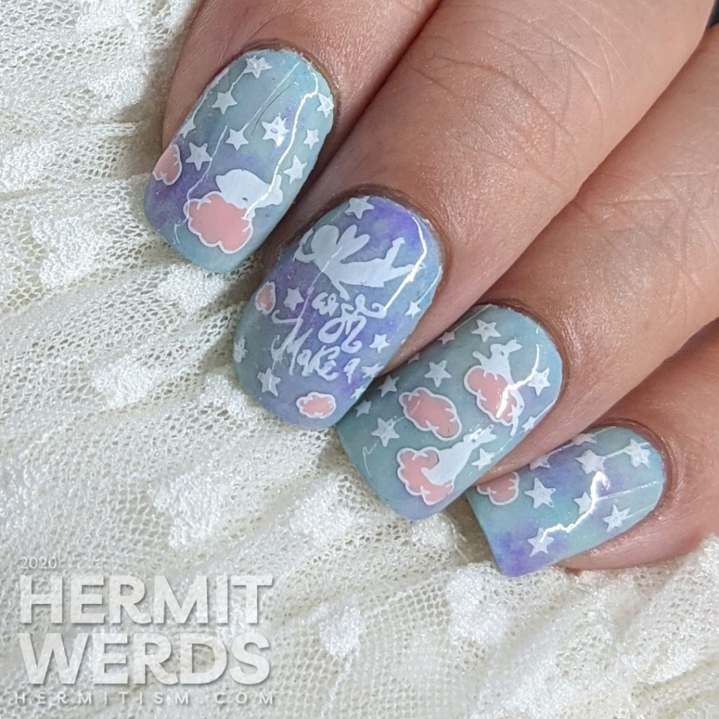 A soft blue, purple, and pink nail art of cute bunnies living in the clouds with an aqua glow in the dark special effect.