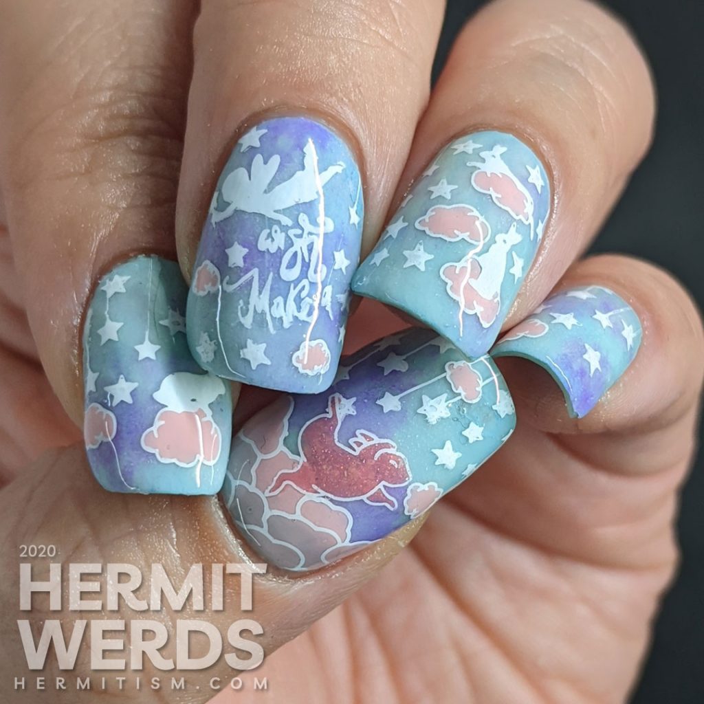 A soft blue, purple, and pink nail art of cute bunnies living in the clouds with an aqua glow in the dark special effect.