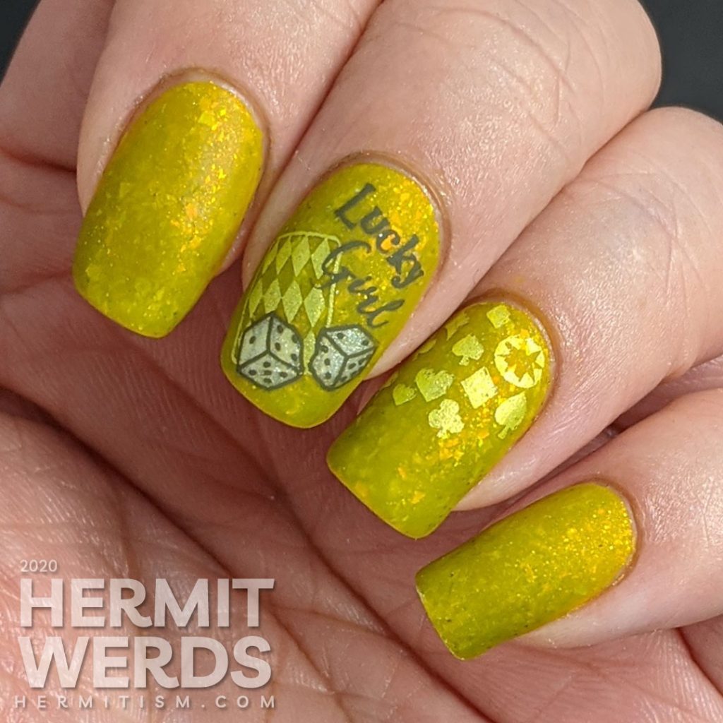 A medium olive/chartreuse nail art with luck, playing cards, dice, and heart/club/spade/diamond stamping decals.