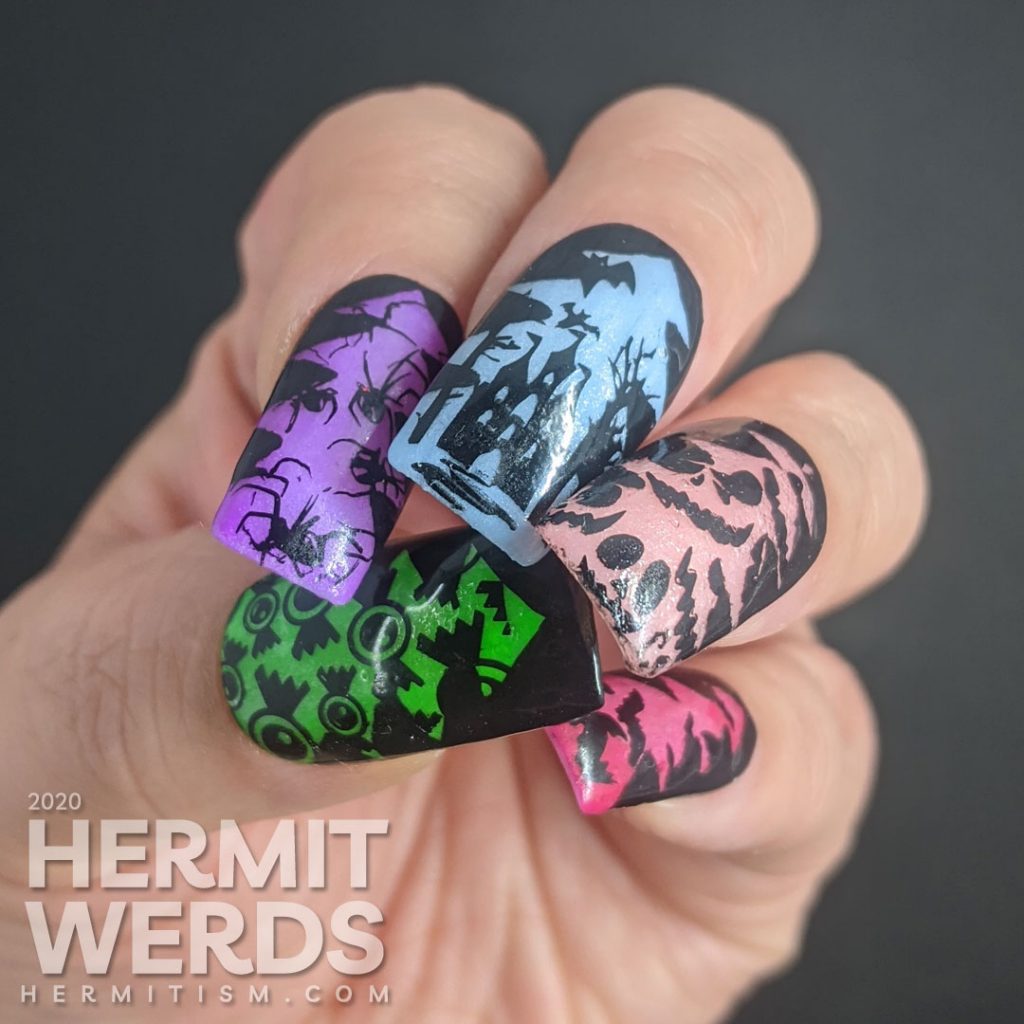 A rainbow glow in the dark mani of silhouetted Halloween images of bats, jack-o-lanterns, haunted castle, spiders, and eyeball candy glowing out from a Christmas tree frame.