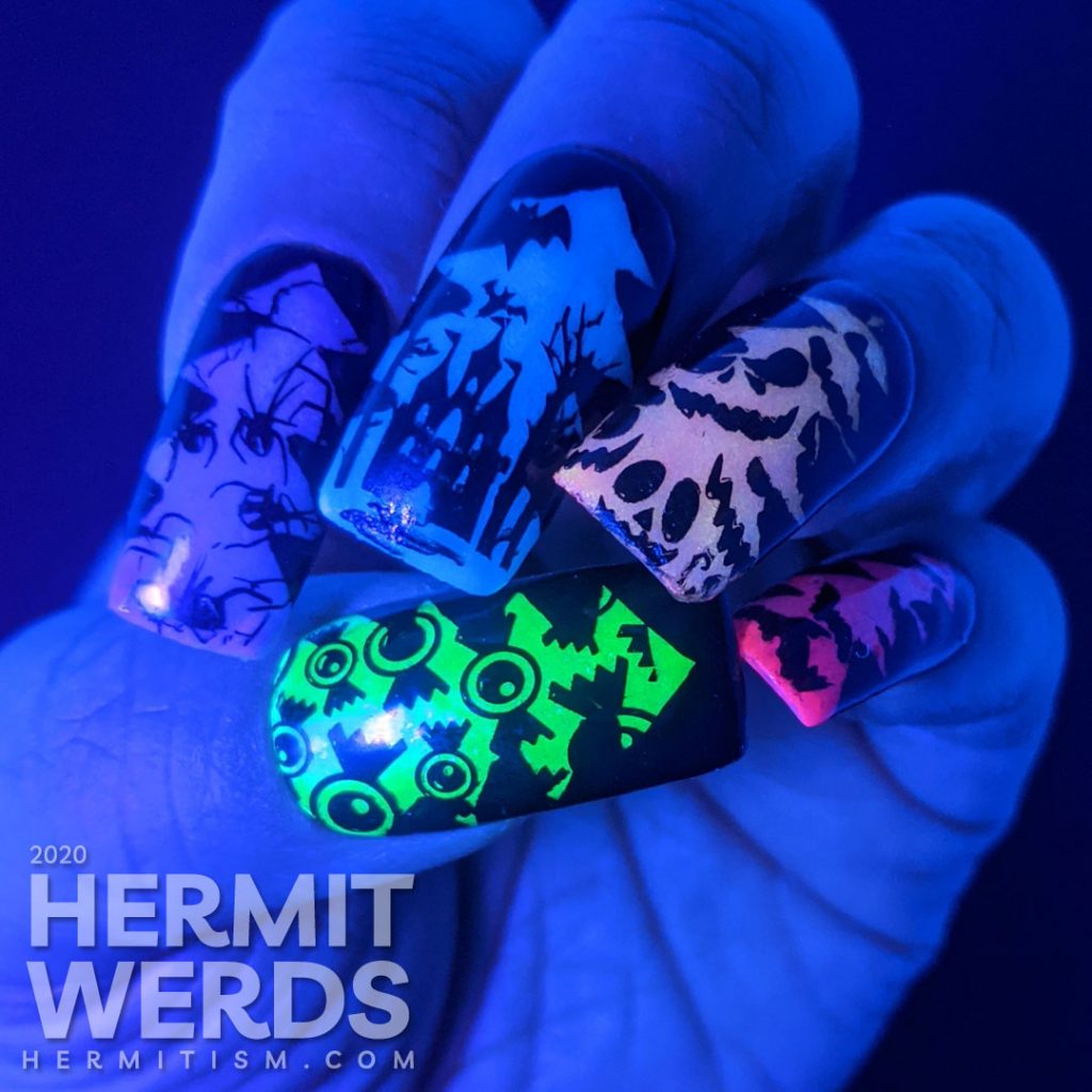 A rainbow glow in the dark mani of silhouetted Halloween images of bats, jack-o-lanterns, haunted castle, spiders, and eyeball candy glowing out from a Christmas tree frame.