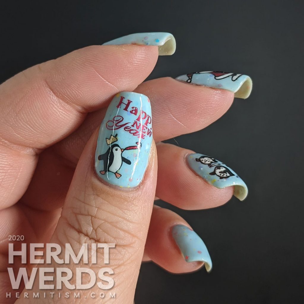 Nail art of Santa handing out fishy presents to cute penguins for Christmas and another penguin celebrating New Years on a blue crelly background.