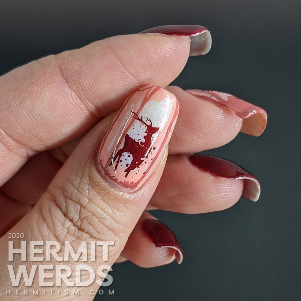 Monochrome red reindeer nail art with deep red polishes and a wintery scene created from layered stamping. Merry Christmas!