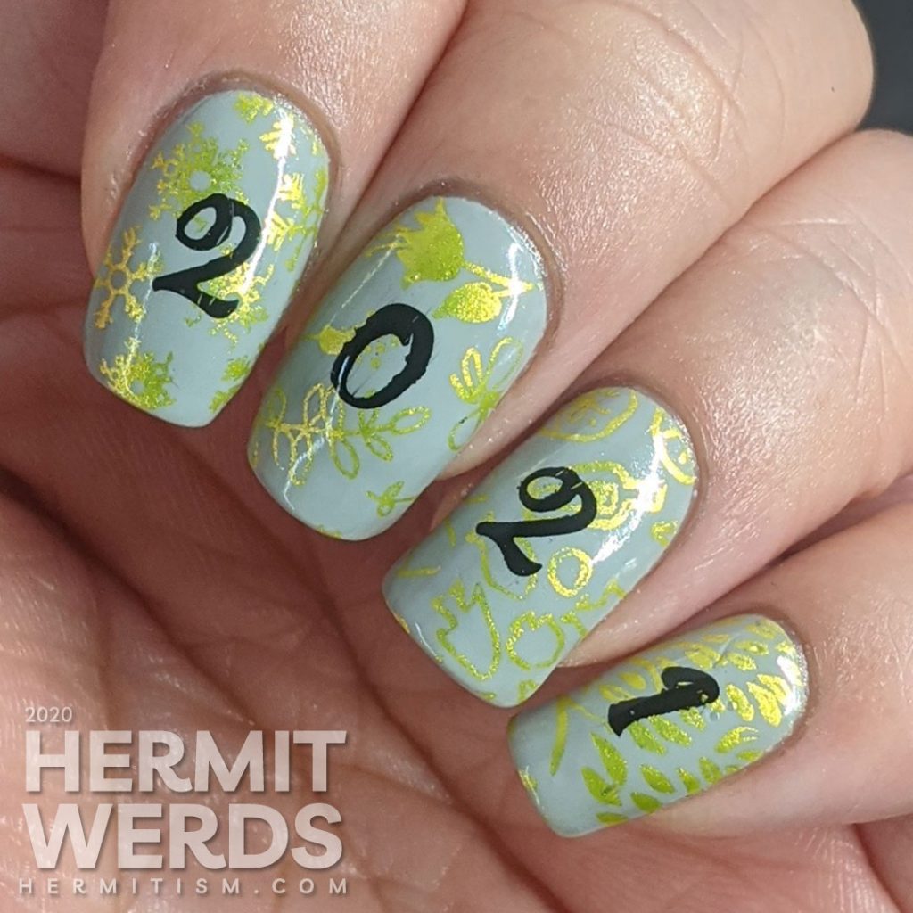 A New Years mani with a grey background, bright green stamping of winter/spring/summer/fall seasons and "2021" on top.