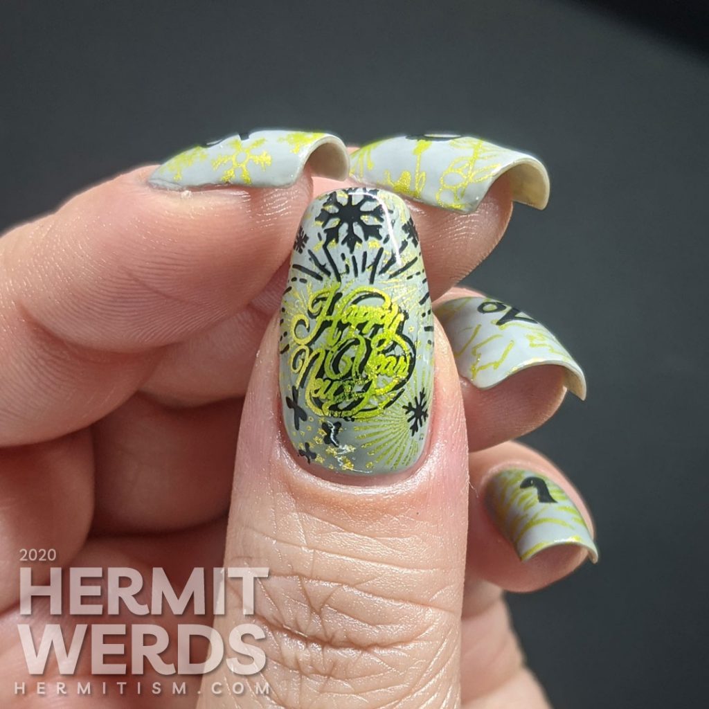 A New Years mani with a grey background, bright green stamping of winter/spring/summer/fall seasons and "2021" on top.