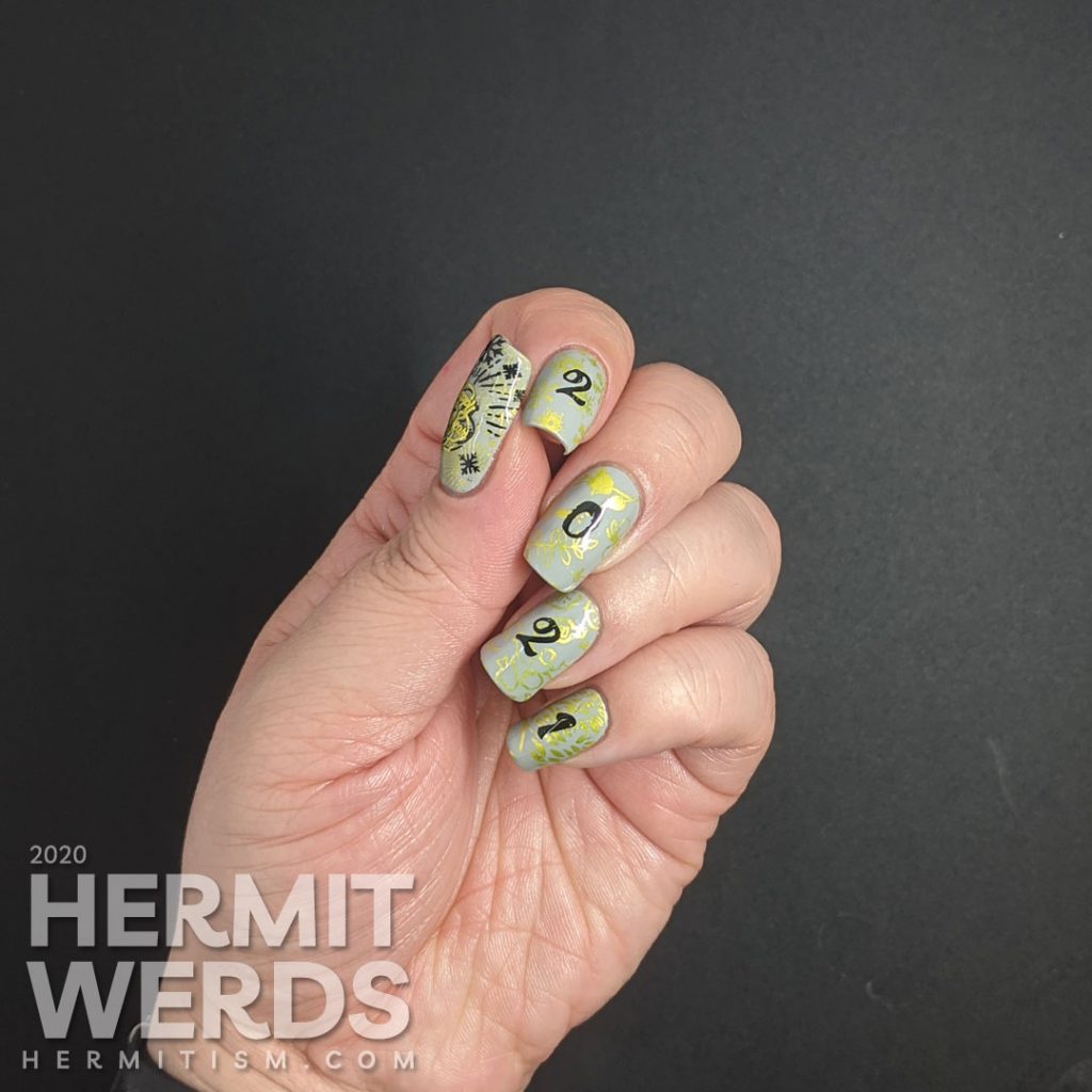 A New Years mani with a grey background, bright green stamping of winter/spring/summer/fall seasons and "2021" on top.