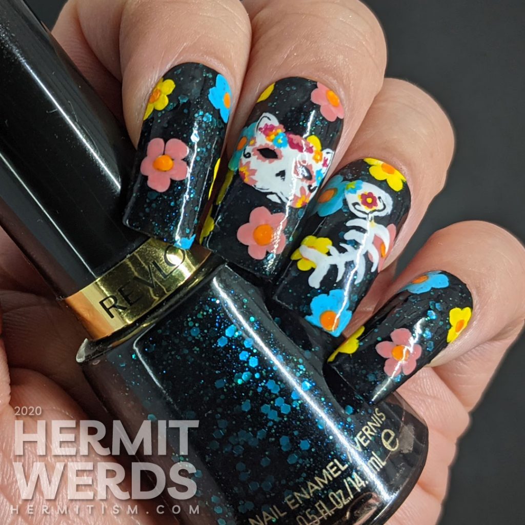 Sugar skull nail art for the Day of the Dead on black jelly teal glitter fake nails with freehand painted cat and fish sugar skulls and flowers.