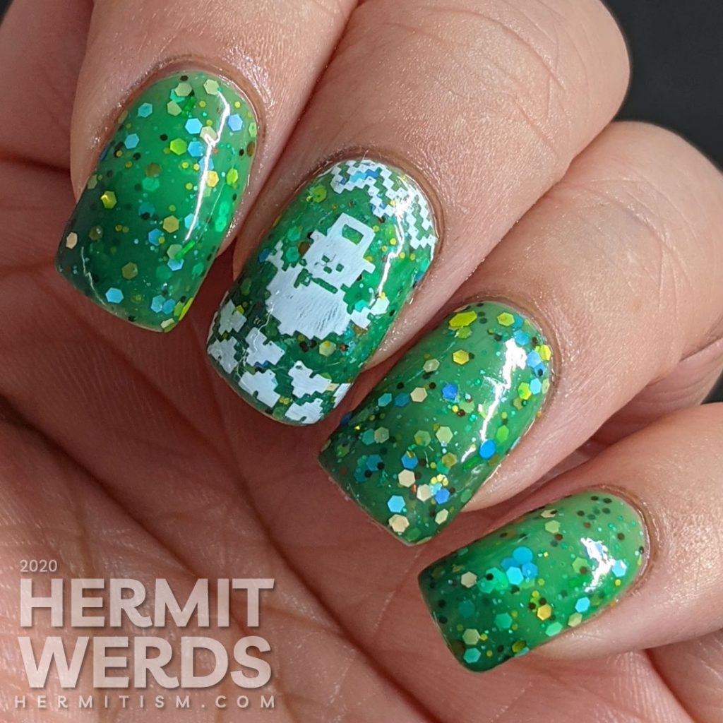 Nail art with blocky sweater pattern stamping on top of a super "tacky" light green to ultramarine green tri-thermal indie polish stuffed with glitter.