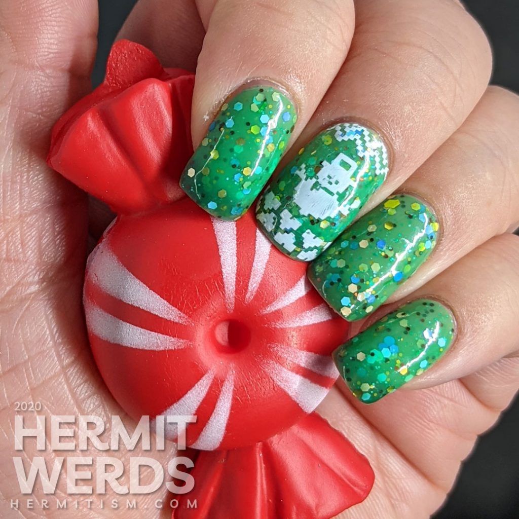 Nail art with blocky sweater pattern stamping on top of a super "tacky" light green to ultramarine green tri-thermal indie polish stuffed with glitter.