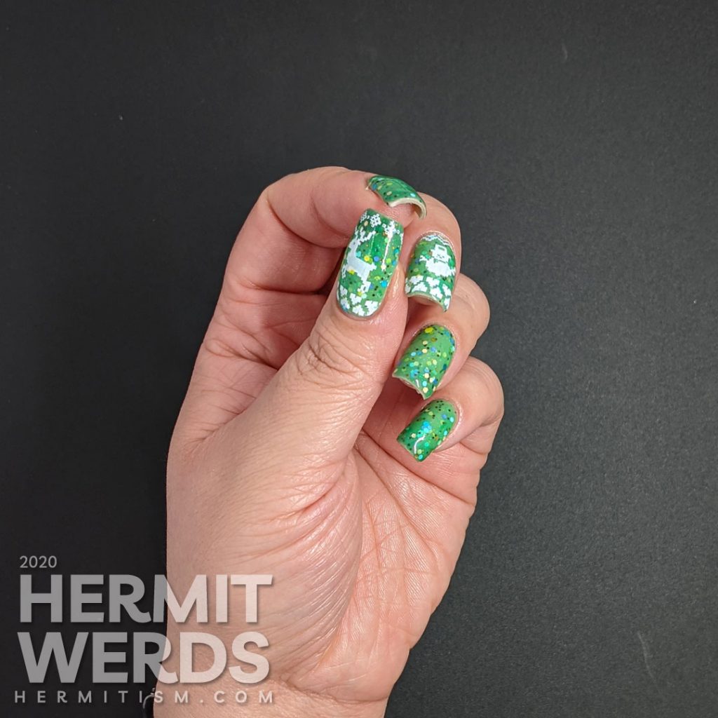 Nail art with blocky sweater pattern stamping on top of a super "tacky" light green to ultramarine green tri-thermal indie polish stuffed with glitter.