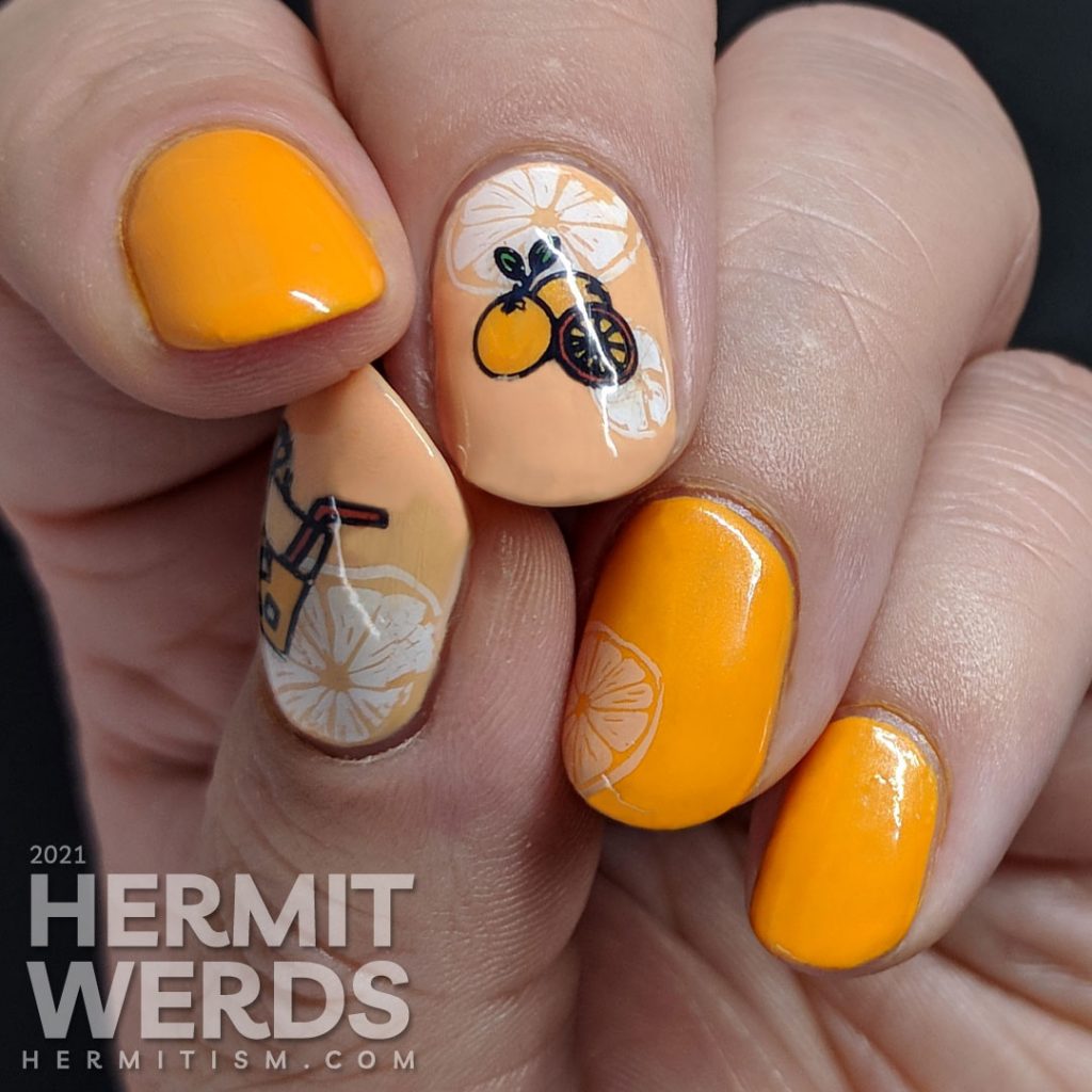 Fruit-themed bright orange nail art with orange slice and orange stamping decals on top.