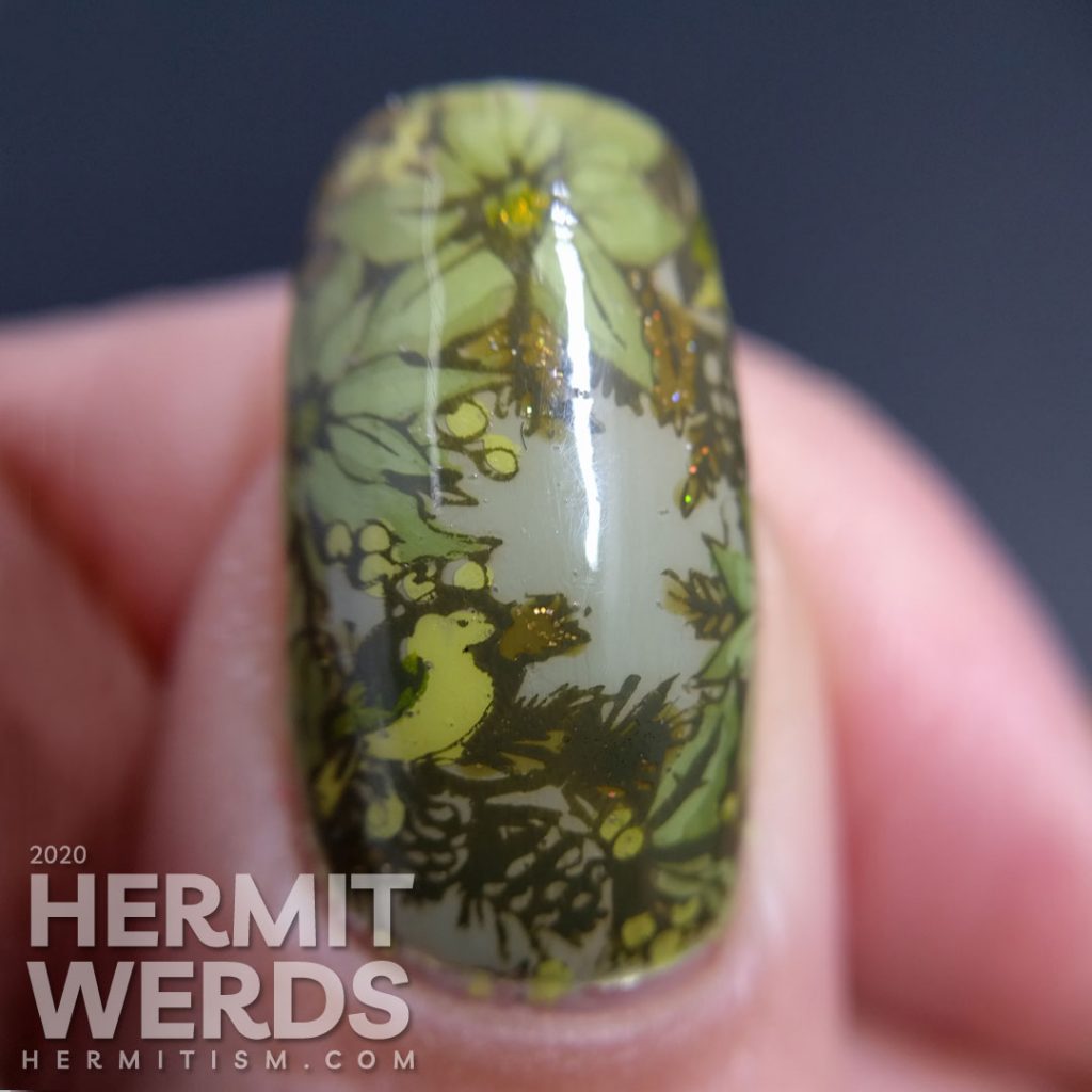 Olive Christmas art featuring accent nails with poinsettia stamping decals and a wee bird and holographic olive polish.