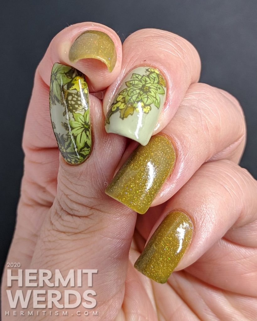 Olive Christmas art featuring accent nails with poinsettia stamping decals and a wee bird and holographic olive polish.