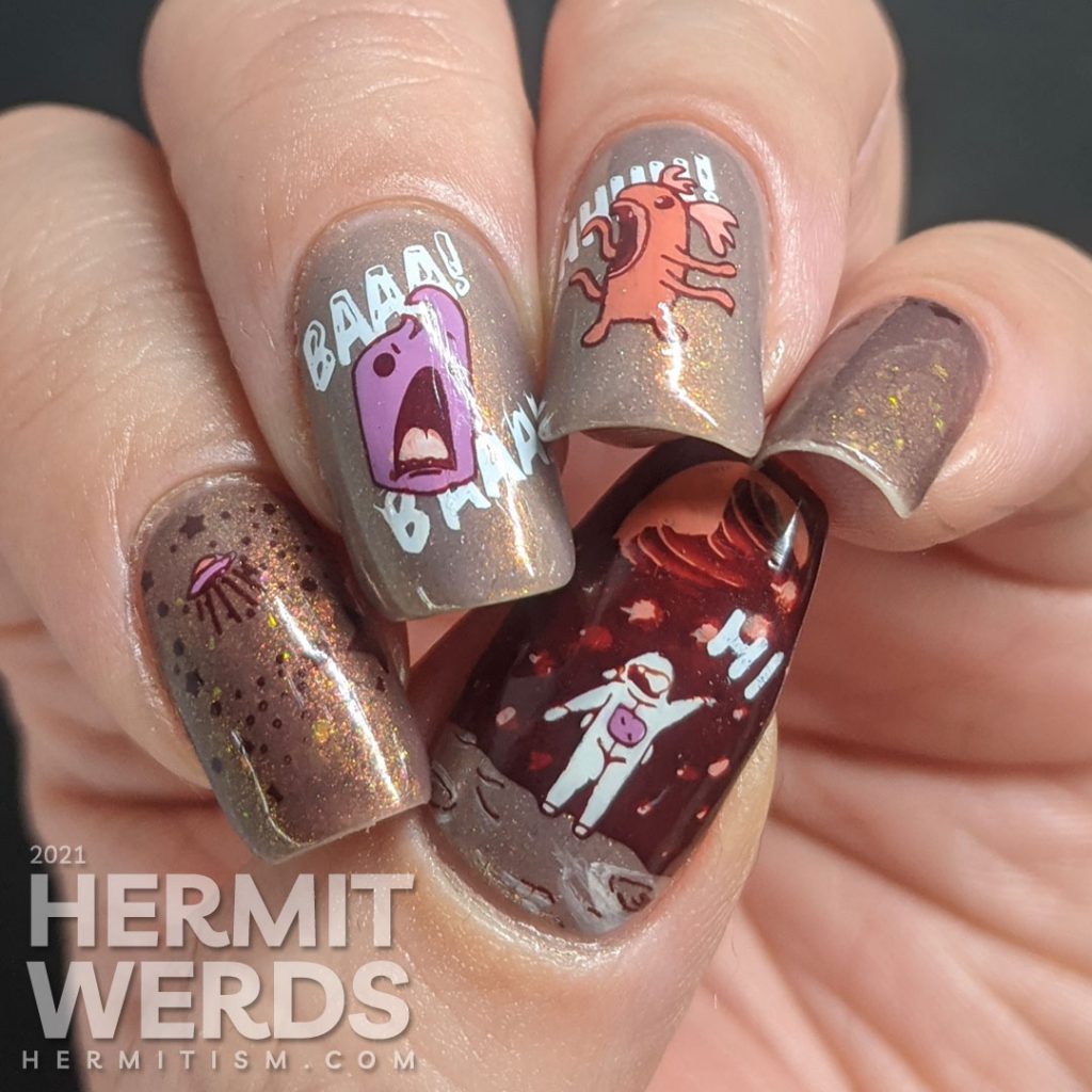 A muted red nail art with a science fiction theme. Cute aliens stamping decals scream at each other while an astronaut says "hi".