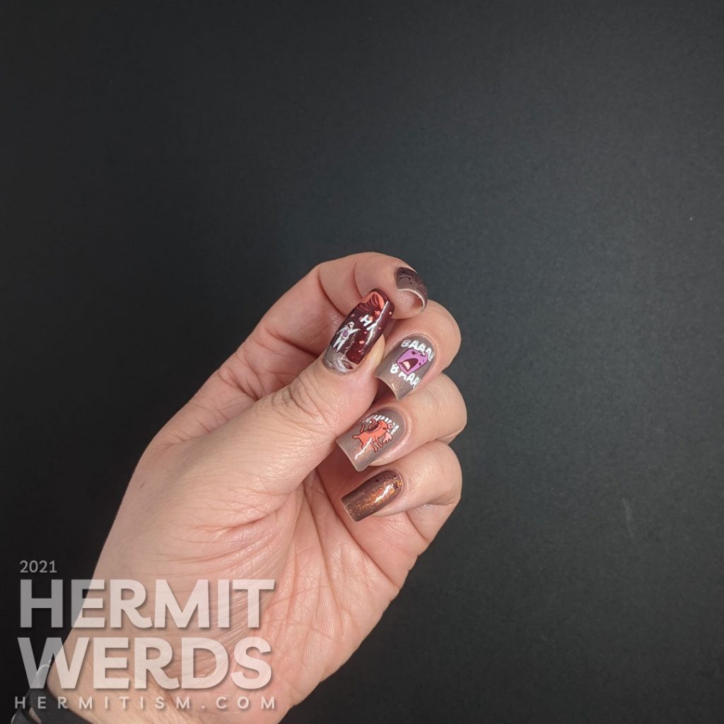 A muted red nail art with a science fiction theme. Cute aliens stamping decals scream at each other while an astronaut says "hi".