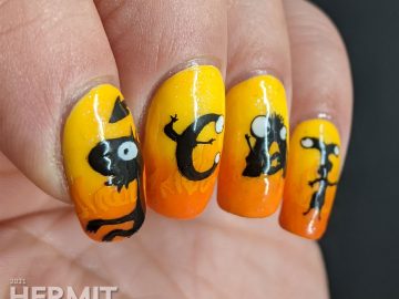 Yellow and orange nail art with the demon Luci (cat) from Netflix's Disenchanted freehand painted on top of flames.