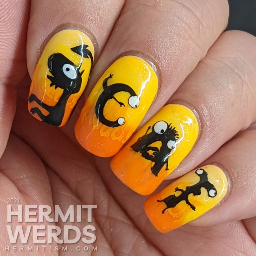 Yellow and orange nail art with the demon Luci (cat) from Netflix's Disenchanted freehand painted on top of flames.