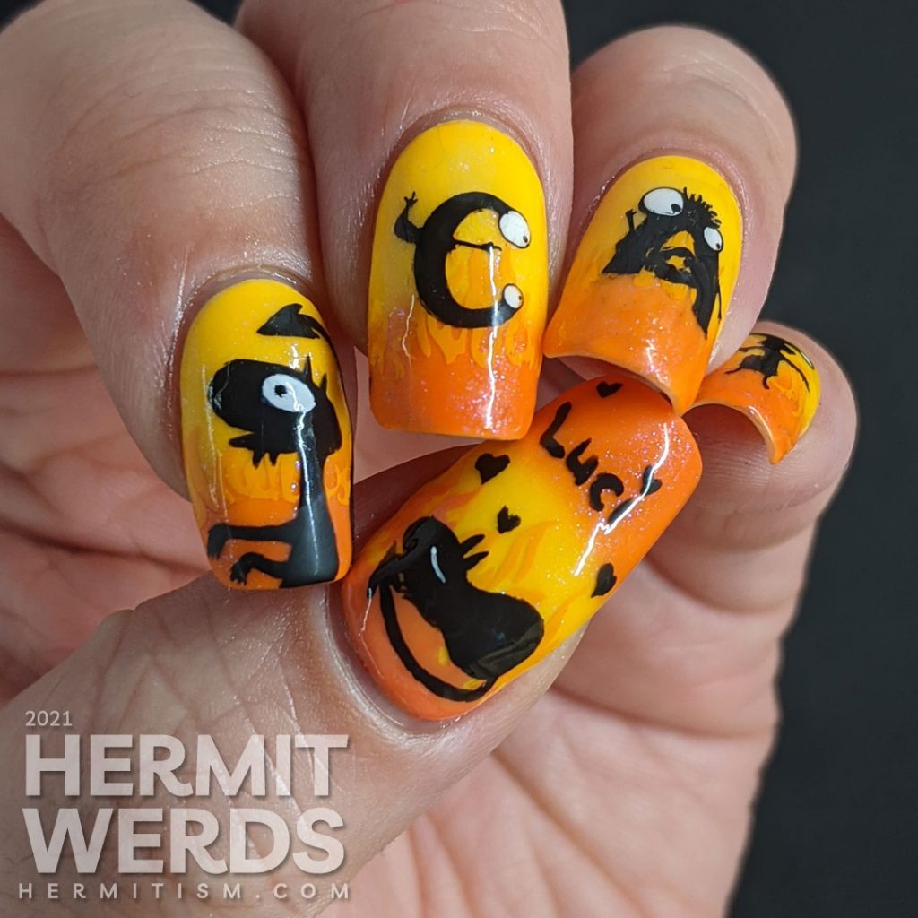 Yellow and orange nail art with the demon Luci (cat) from Netflix's Disenchanted freehand painted on top of flames.