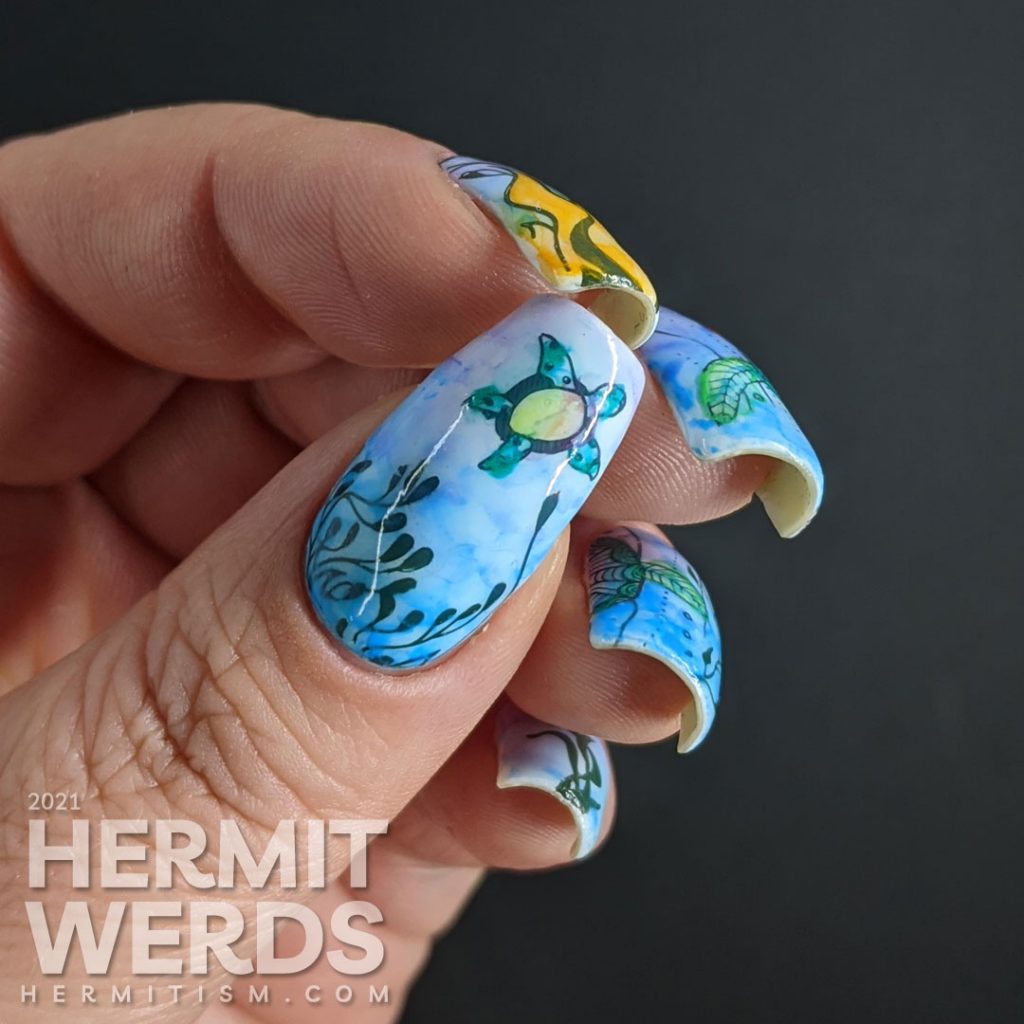 A watercolor nail art with a sea turtle with mandala-esque patterns and lots of kelp colored in with actual watercolor paint.