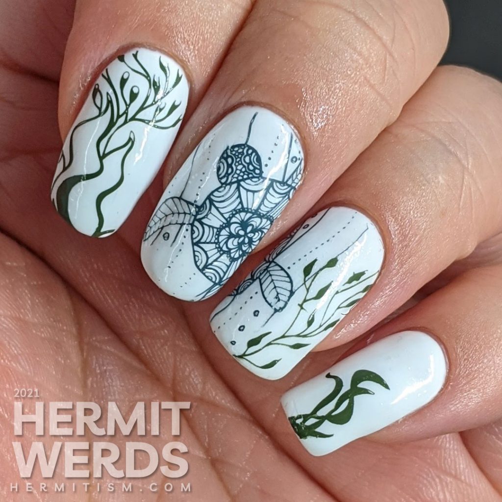 A watercolor nail art with a sea turtle with mandala-esque patterns and lots of kelp colored in with actual watercolor paint.