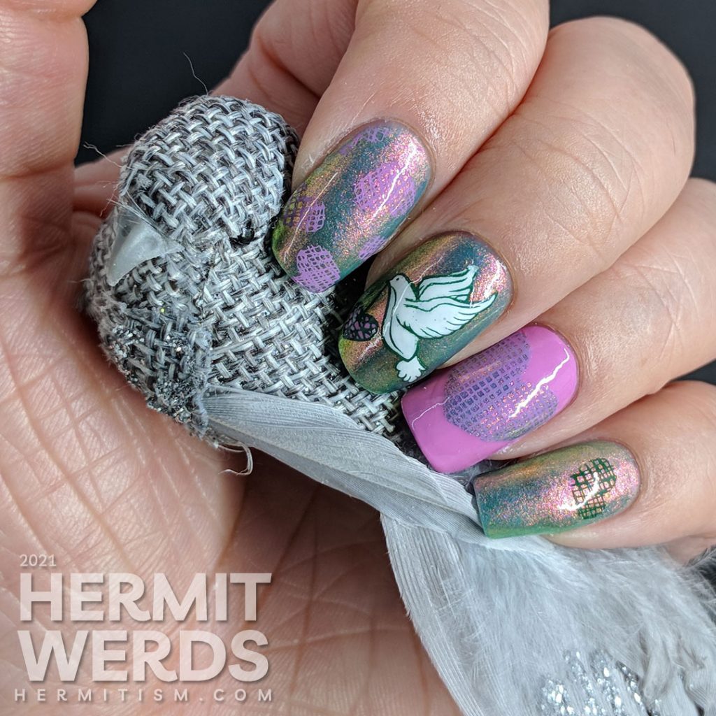 A pink to green shimmery base polish covered with soft green, purple-pink, and white stamping decals of a dove and crosshatch hearts.