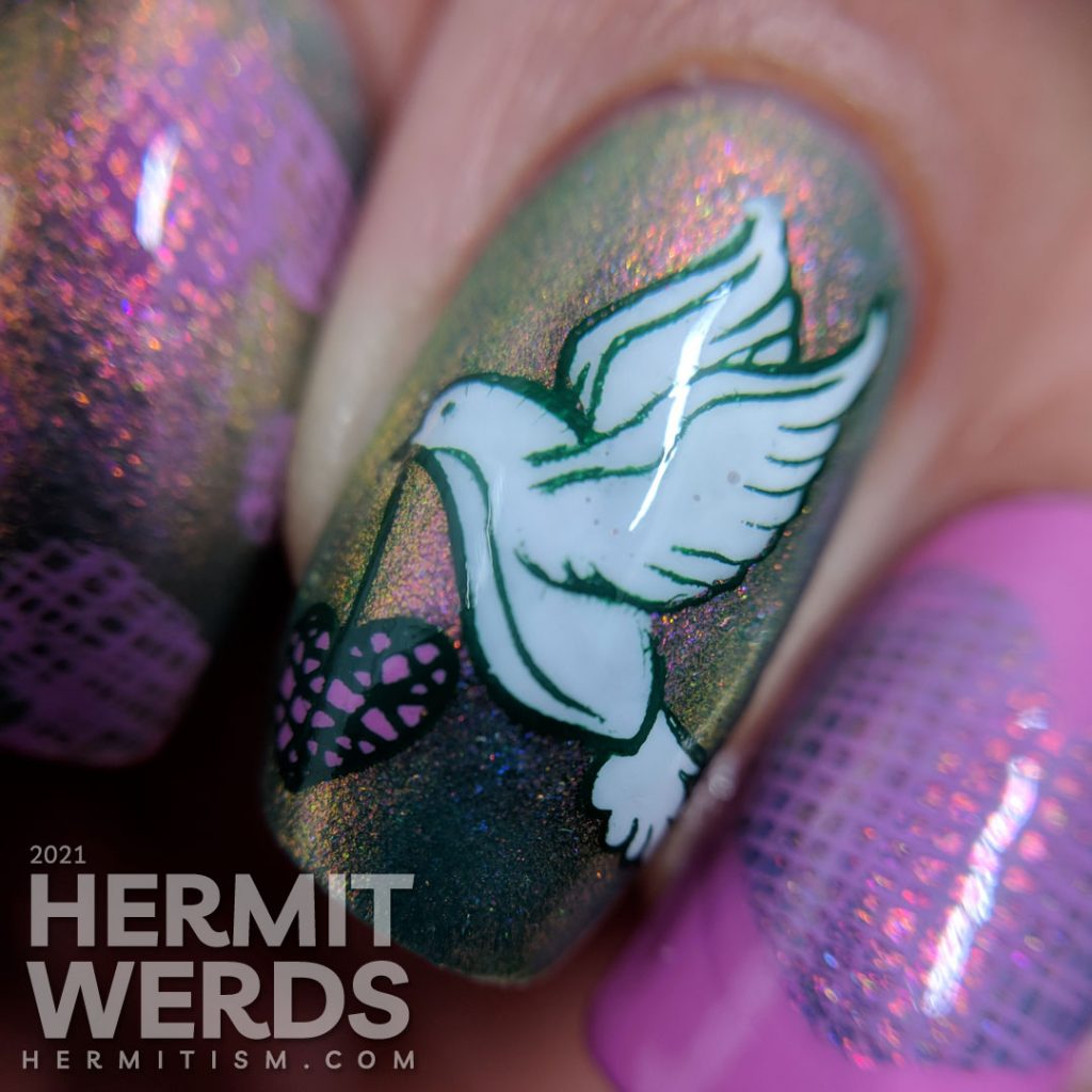 A pink to green shimmery base polish covered with soft green, purple-pink, and white stamping decals of a dove and crosshatch hearts.