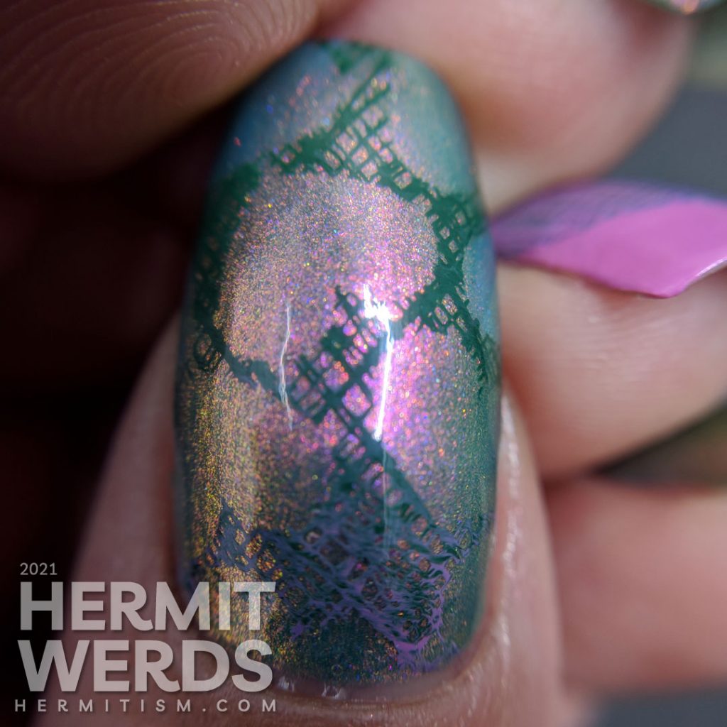 A pink to green shimmery base polish covered with soft green, purple-pink, and white stamping decals of a dove and crosshatch hearts.