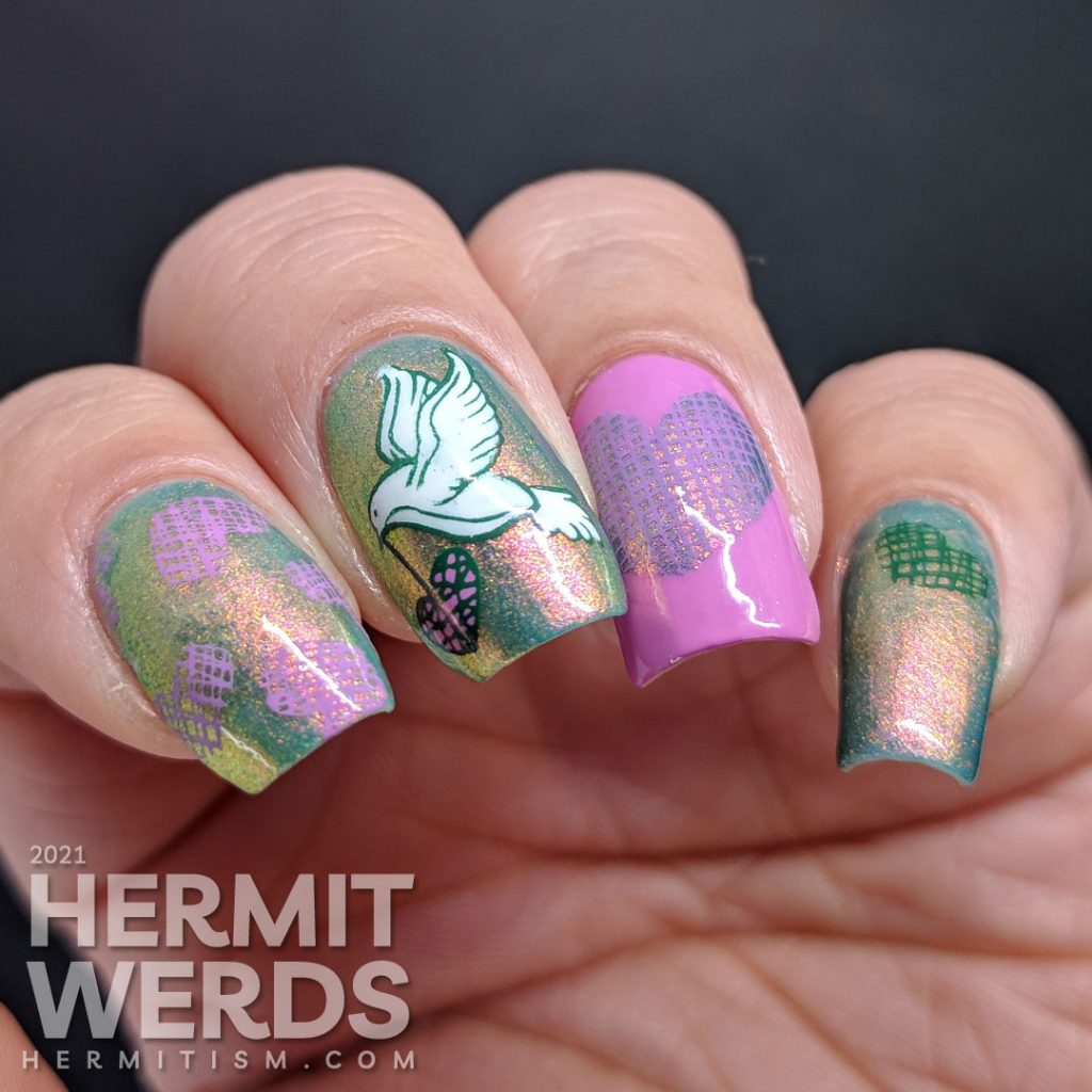 A pink to green shimmery base polish covered with soft green, purple-pink, and white stamping decals of a dove and crosshatch hearts.