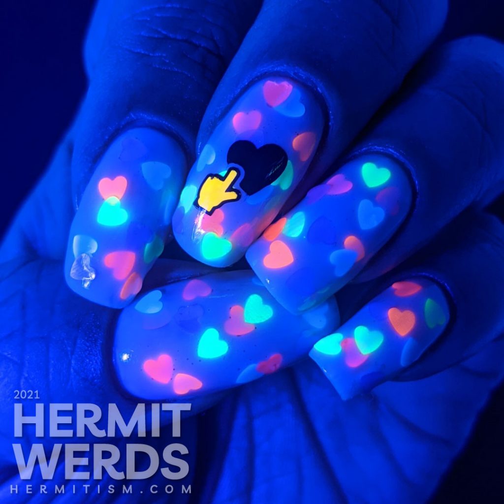 A white jelly pond mani with a neon rainbow of fluorescent heart sequins. Glow-y black light photos included.