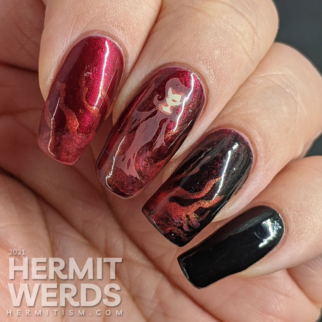 A red to black gradient nail art with swirls of magic and a wicked, sexy witch casting a summoning stamped on top plus a haunted house.