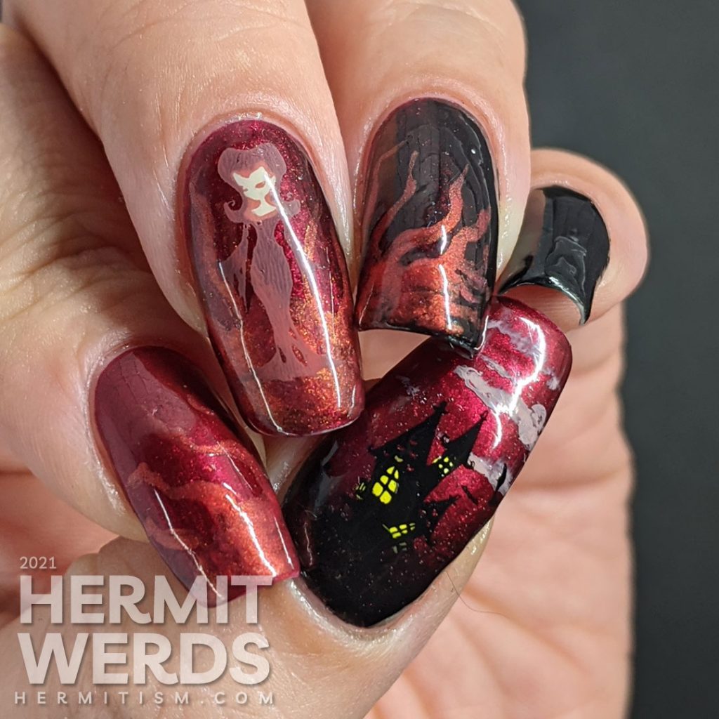 A red to black gradient nail art with swirls of magic and a wicked, sexy witch casting a summoning stamped on top plus a haunted house.