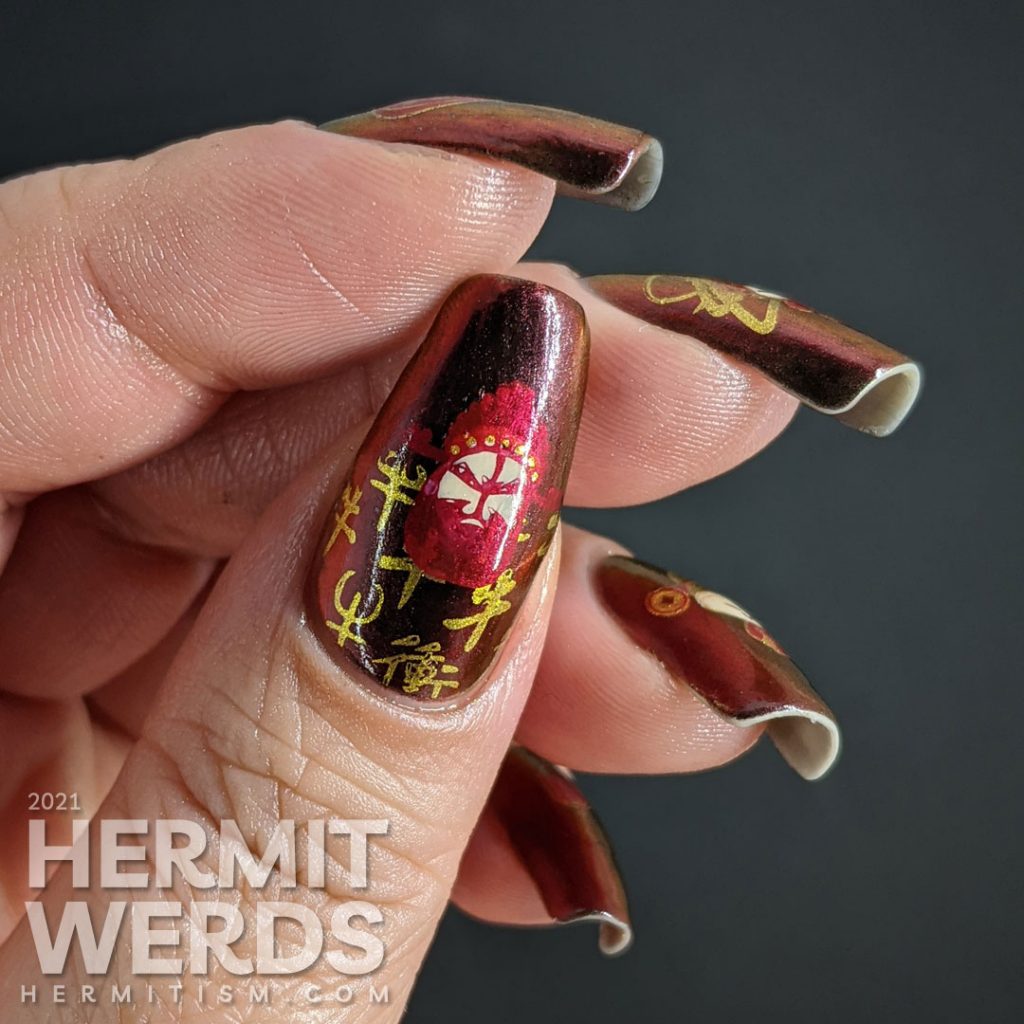 Year of the Ox nail art on a black/red/gold multichrome base with chibi Chinese opera performers, lanterns, and ox symbols.