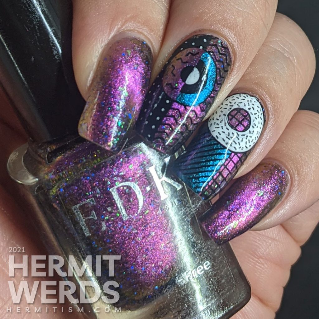 A gorgeous multichrome indie magnetic polish with abstract donut shapes and very 80s patterns stamped on top.