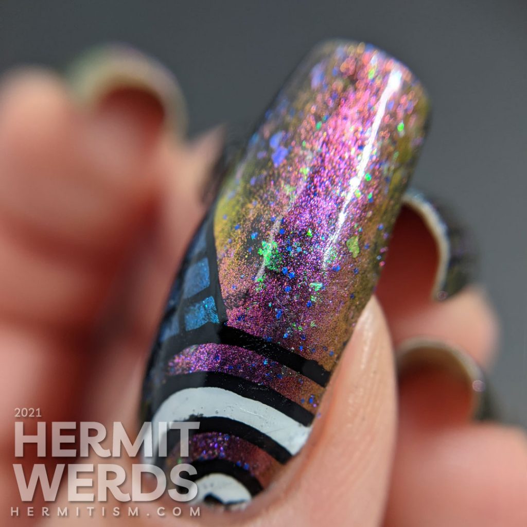 A gorgeous multichrome indie magnetic polish with abstract donut shapes and very 80s patterns stamped on top.