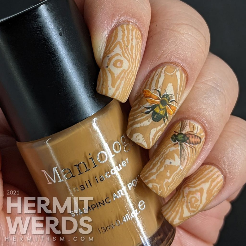 A soft tan and caramel wood texture nail art with bright water decal bugs on top.