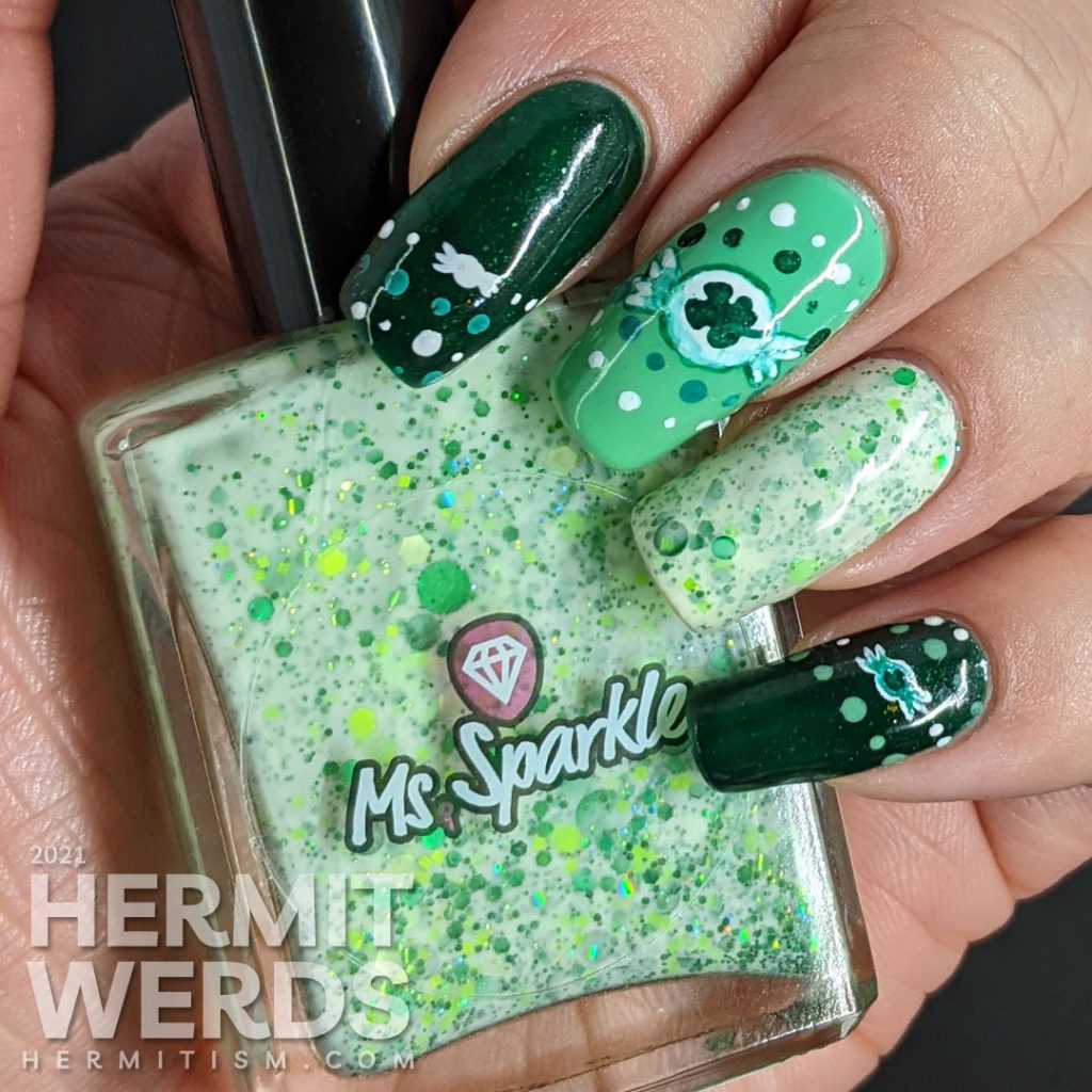 A dotticure clover candy nail art with freehand painted clover hard candies and polka dot patterns.