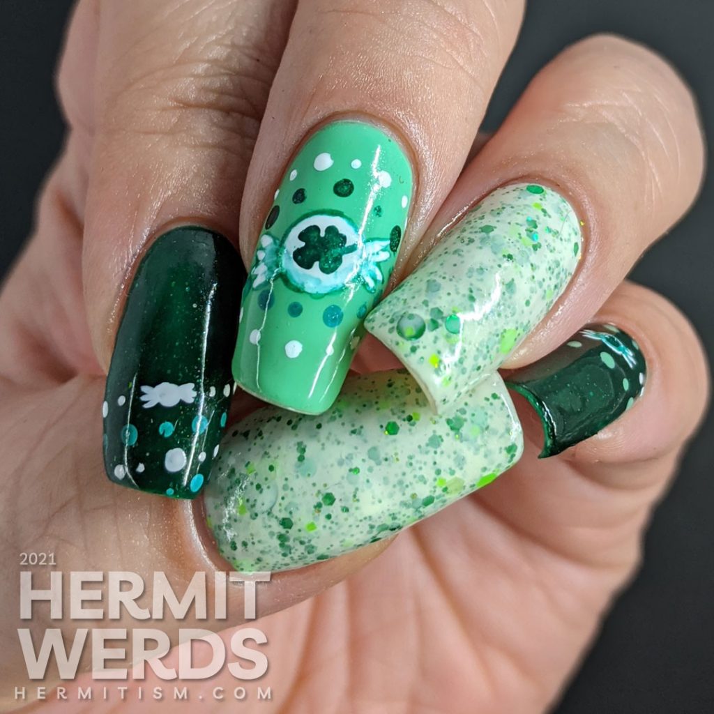 A dotticure clover candy nail art with freehand painted clover hard candies and polka dot patterns.