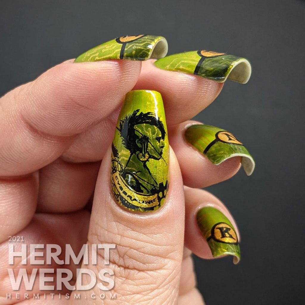 A green gold circuit board mani with "PUNK" French tips and a cyberpunk mohawked lady on the thumb.