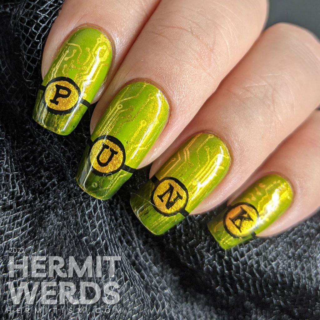 A green gold circuit board mani with "PUNK" French tips and a cyberpunk mohawked lady on the thumb.