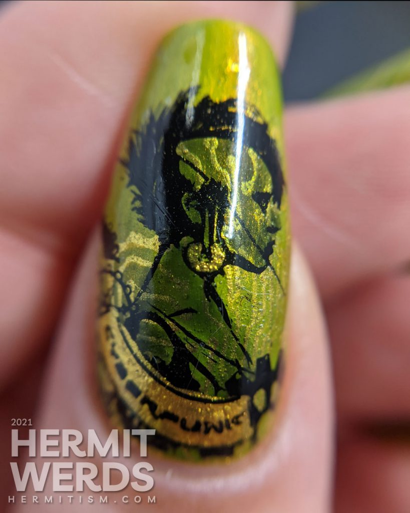 A green gold circuit board mani with "PUNK" French tips and a cyberpunk mohawked lady on the thumb.