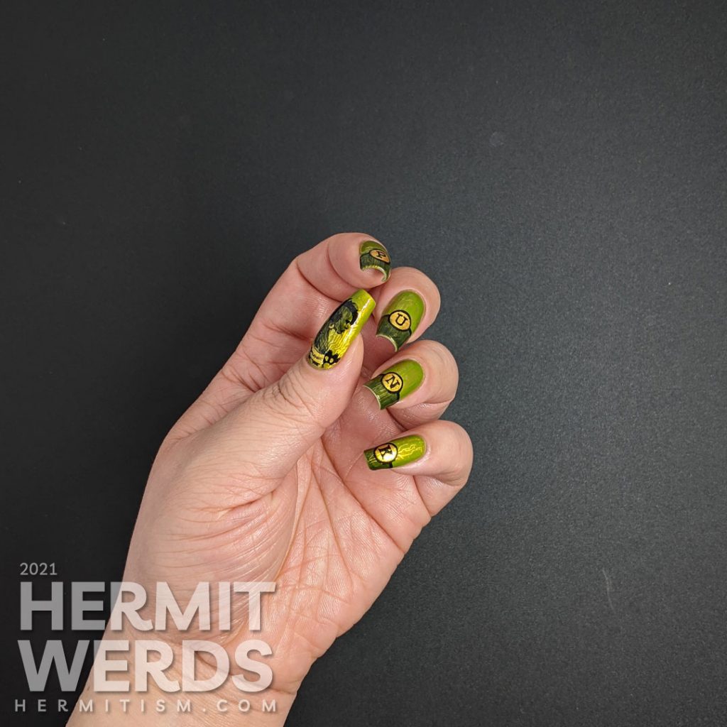 A green gold circuit board mani with "PUNK" French tips and a cyberpunk mohawked lady on the thumb.