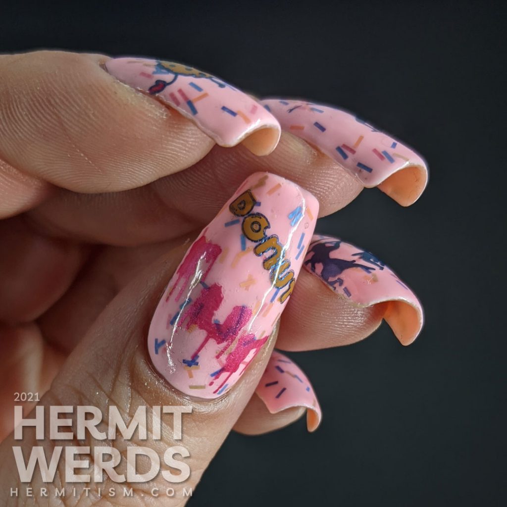 A sweet pink nail art using Sinful Colors' "Donut Even" with bar glitter sprinkles and a donut stamping decal running away from a group of hunters.