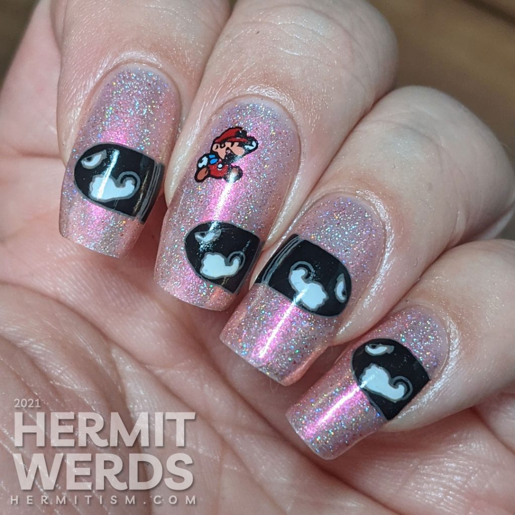 A pink to gold multichrome with holographic nail art featuring Nintendo's Mario dodging multiple Bullet Bills.
