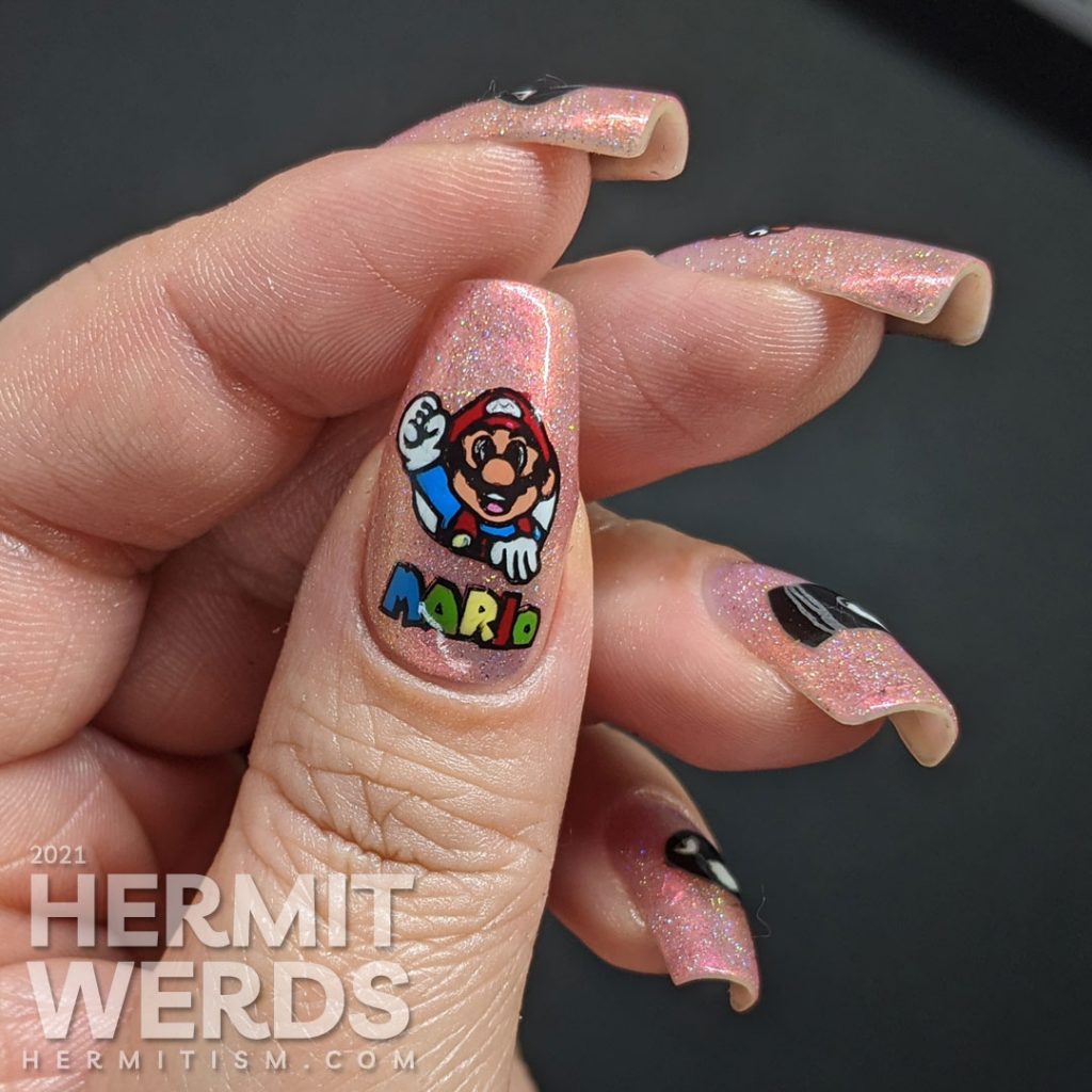 A pink to gold multichrome with holographic nail art featuring Nintendo's Mario dodging multiple Bullet Bills.