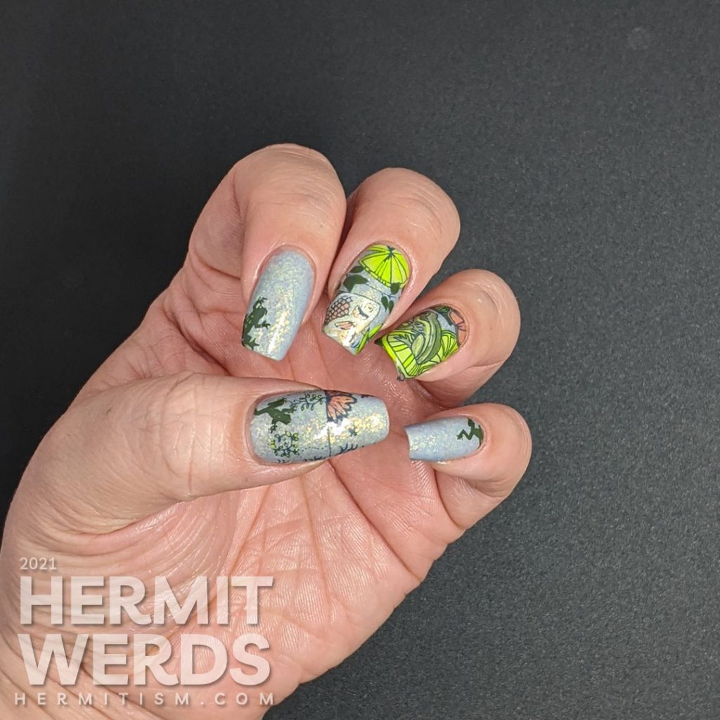 A soft blue-green mani of pond life, mostly frogs and one fish stamping decal with lily pads and other pond greenery.