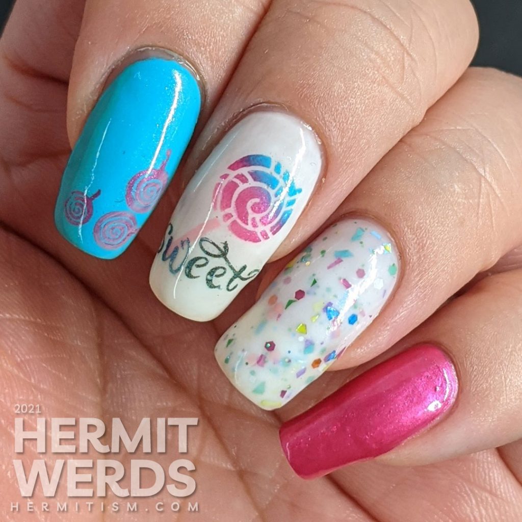 Cute candy nail art in blue, pink, and white with lollipop stamping decals, the word "sweet", and a rainbow crelly.