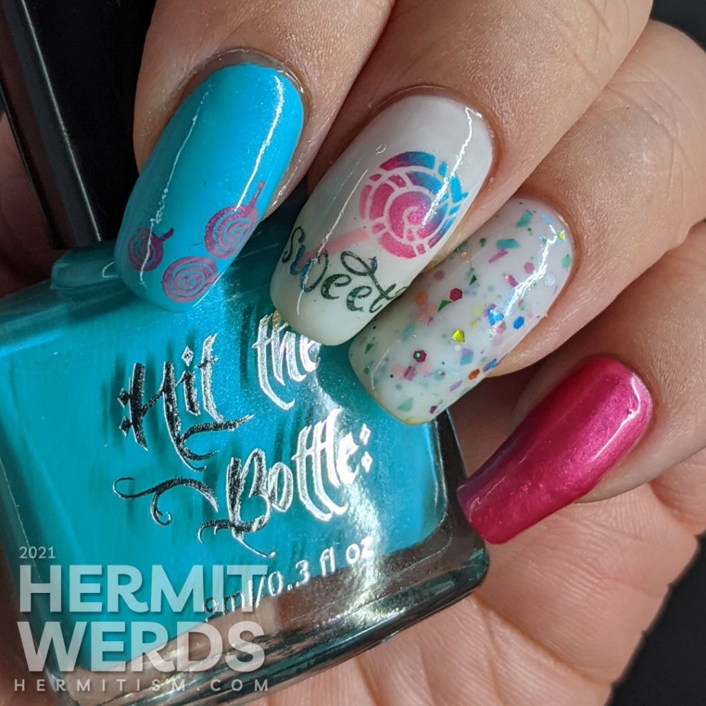 Cute candy nail art in blue, pink, and white with lollipop stamping decals, the word "sweet", and a rainbow crelly.