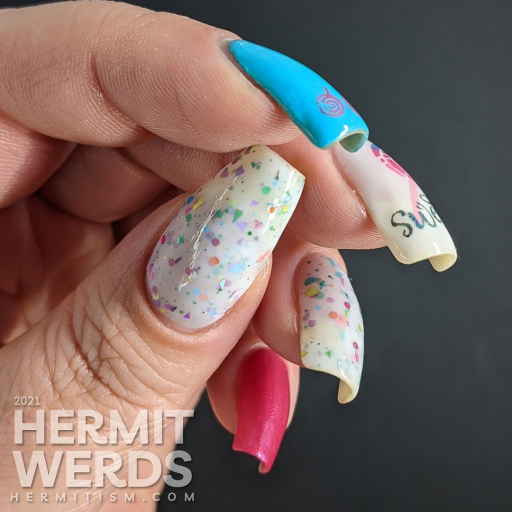 Cute candy nail art in blue, pink, and white with lollipop stamping decals, the word "sweet", and a rainbow crelly.