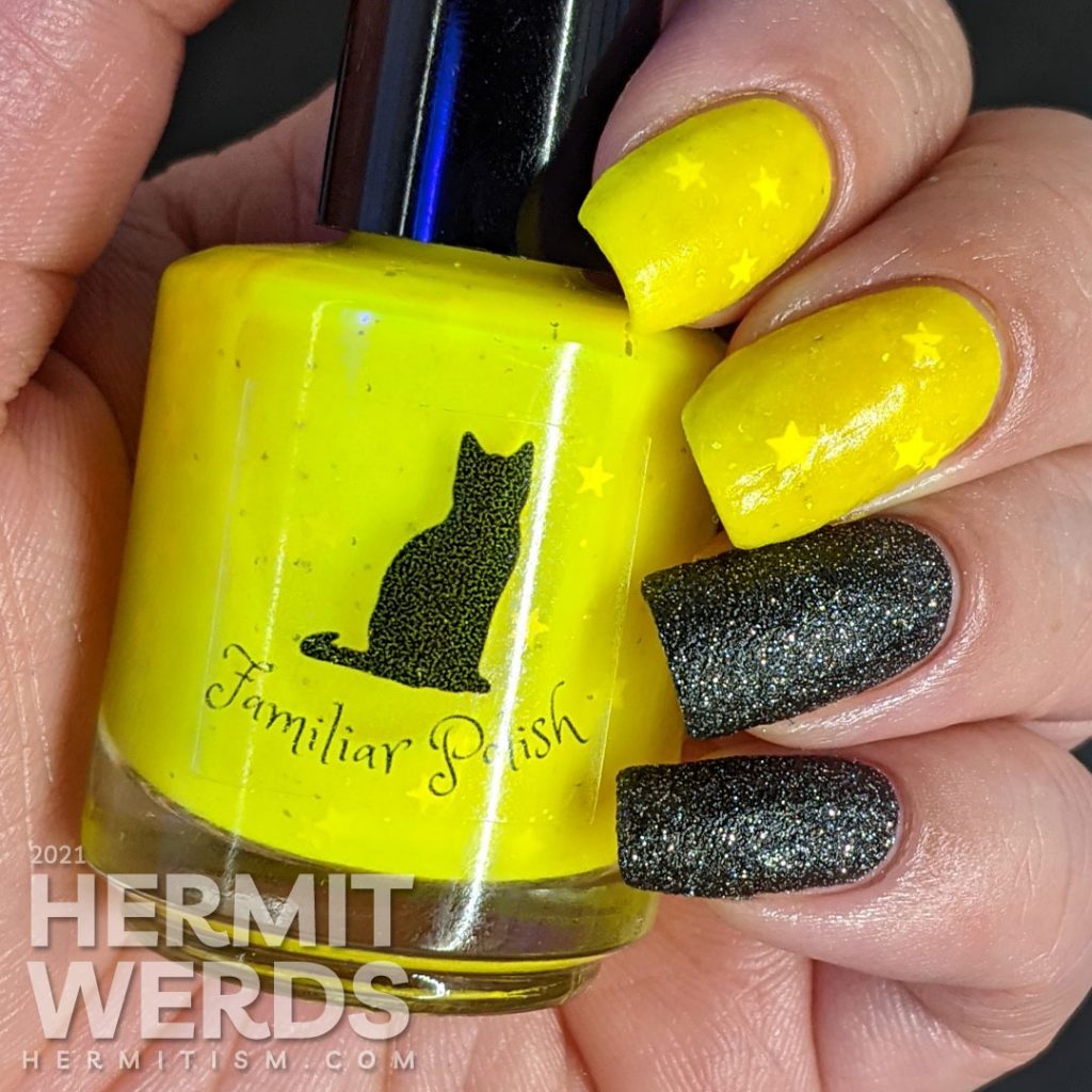 A neon yellow crelly and black texture polish manicure. Glows in the dark.