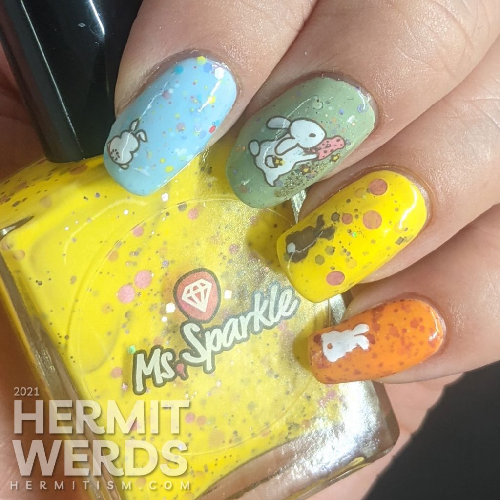 A pastel Easter crelly skittle nail design with a magical bunny, cute bunny butts, and a bunny in a jar for next year.